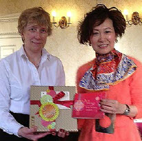 Jennifer Pierce, President of LES Britain & Ireland, receives a gift from Yvonne Chua.